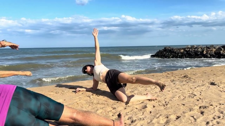 Rotem demonstrating a side-plank rotation on the beach